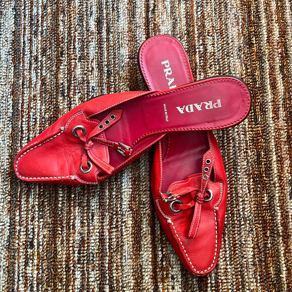 Vibrant red PRADA mules, with a slip-on style for comfortable wear.